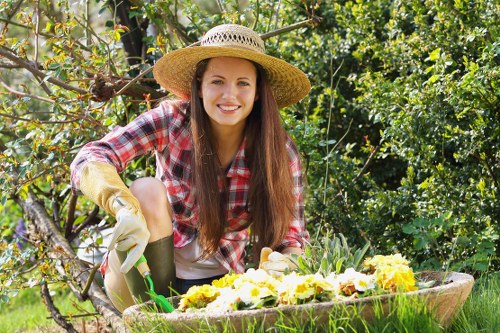 Volunteers turning compost in sustainable gardening area
